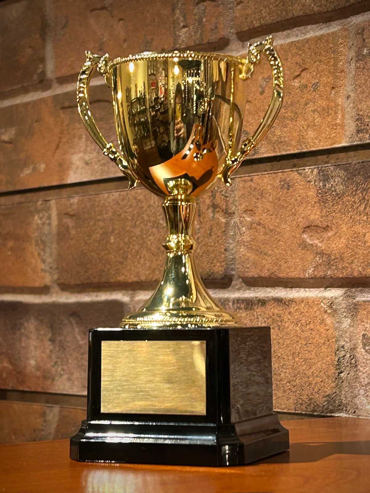 Gold Metal Trophy Cup on Black Base