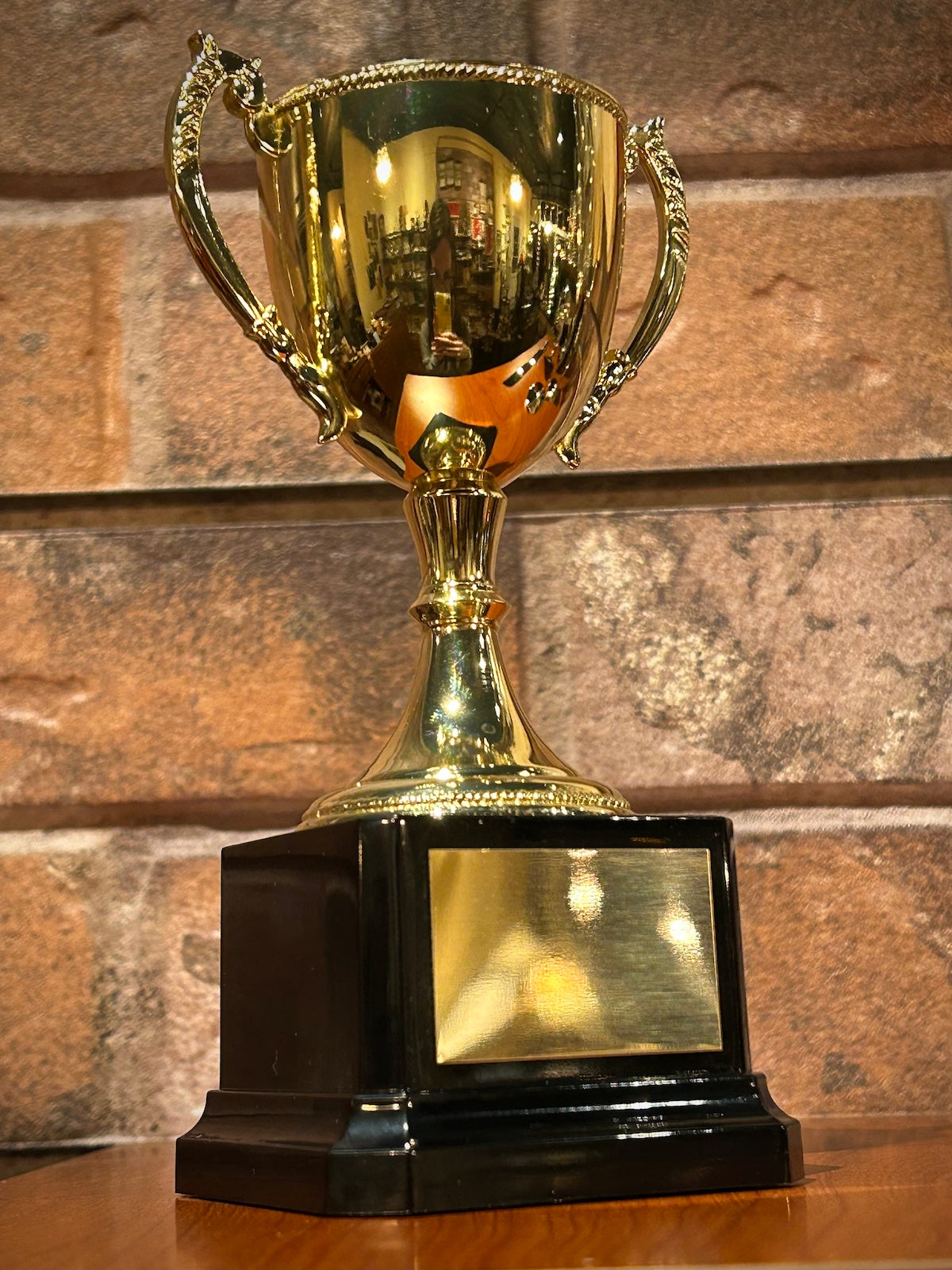 Gold Metal Trophy Cup on Black Base