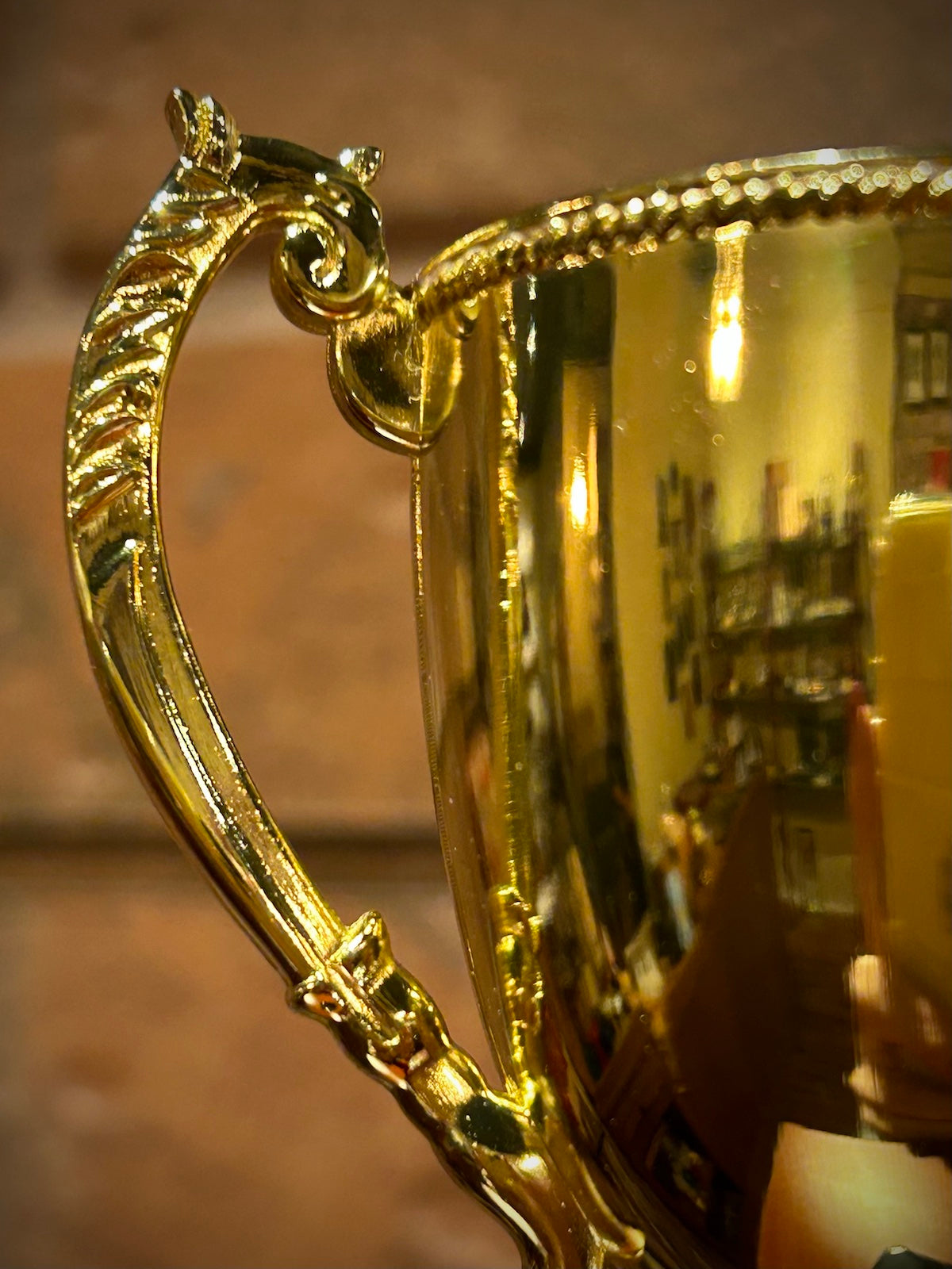 Gold Metal Trophy Cup on Black Base